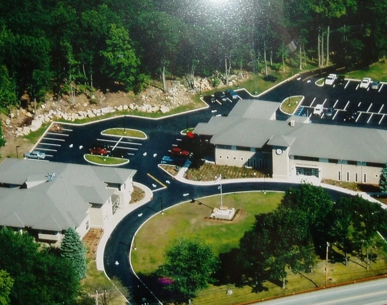 A bird 's eye view of a road with buildings and trees.