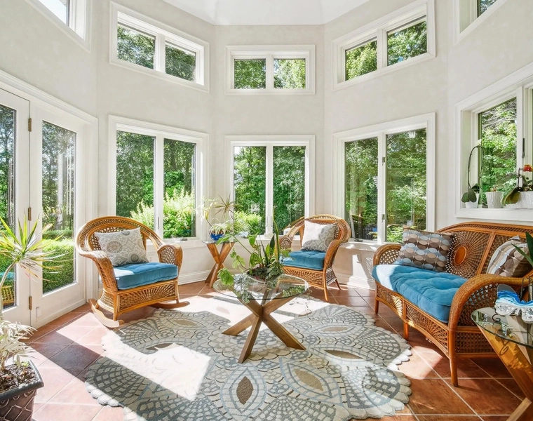 A living room with many windows and furniture