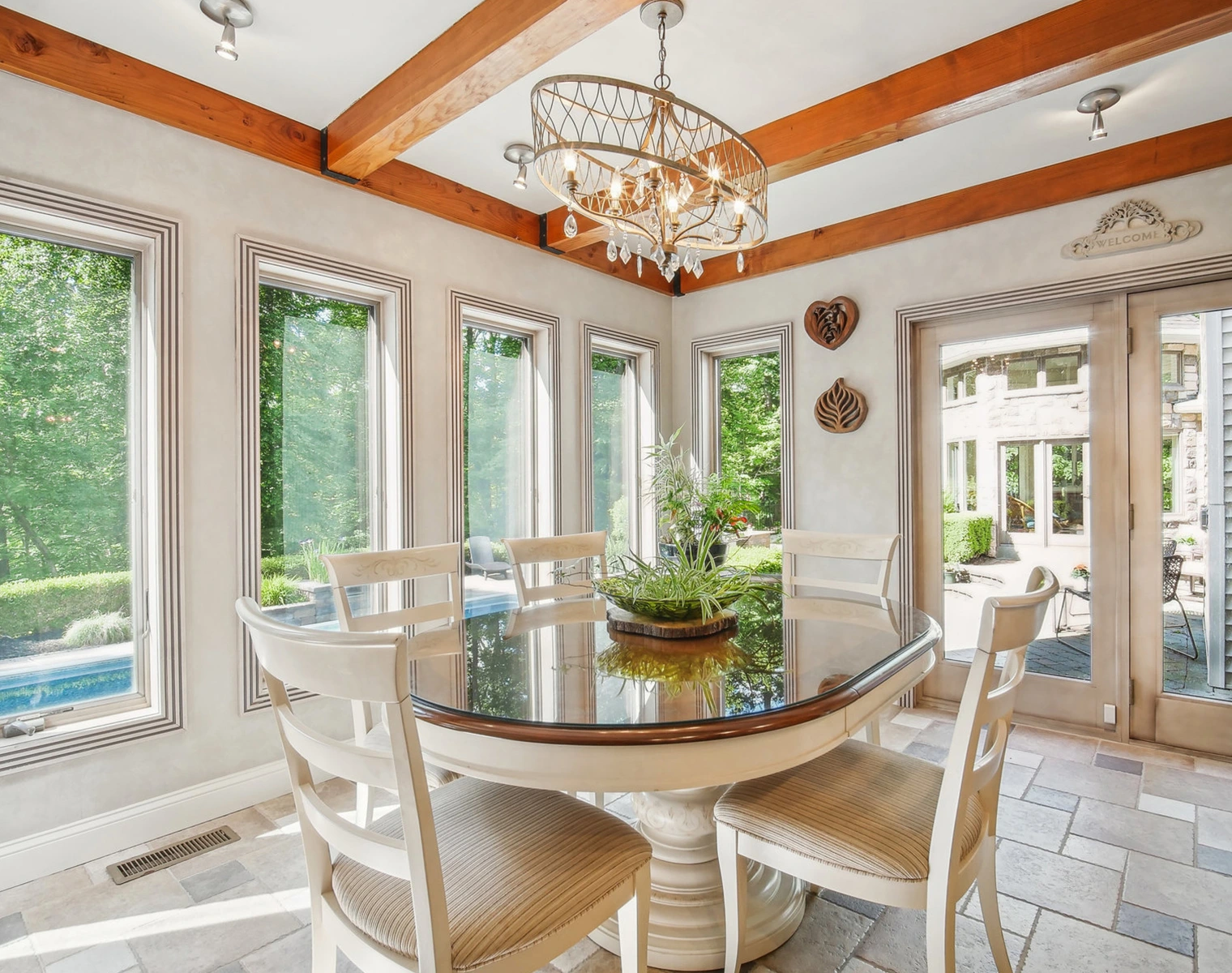 A dining room with white chairs and a table